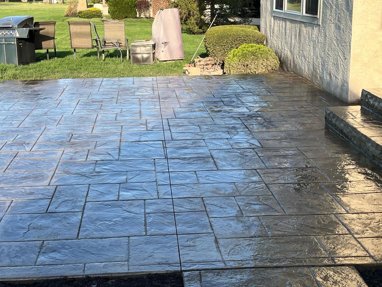 Charcoal ashlar stamped concrete patio after sealing