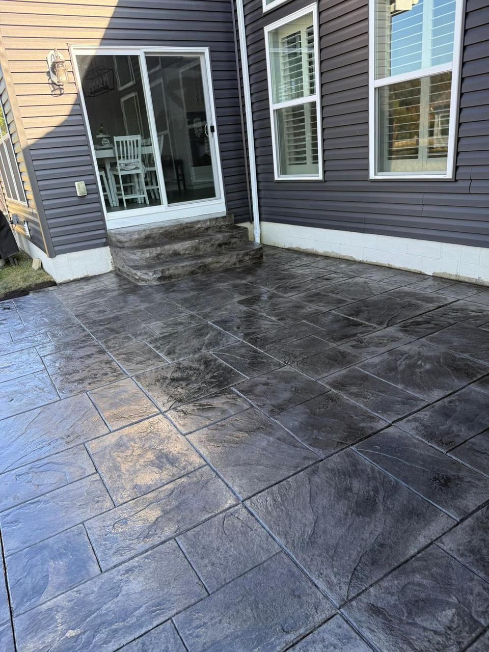 Dark slate stamped concrete patio with steps