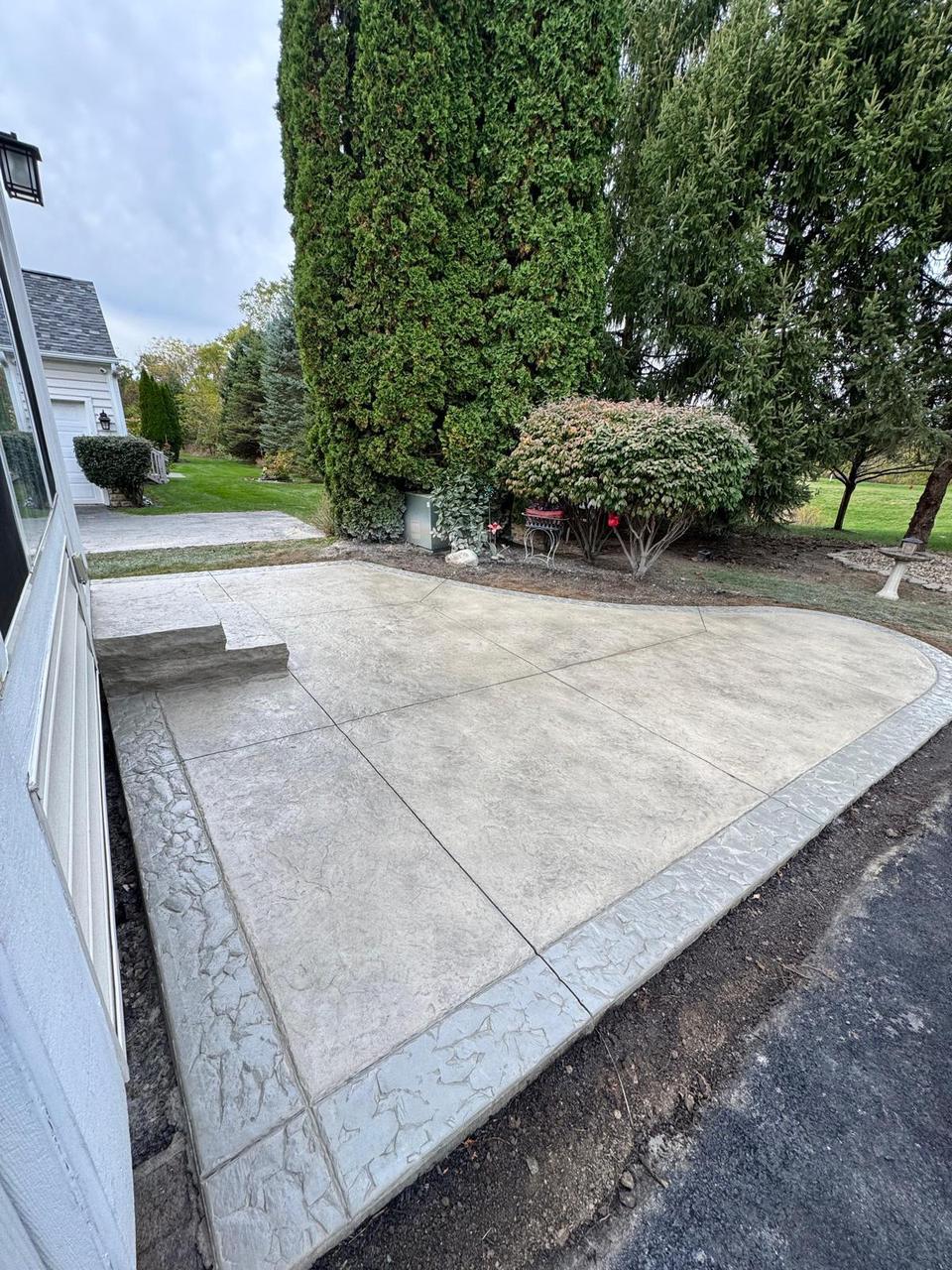 Grey stamped concrete patio with decorative border