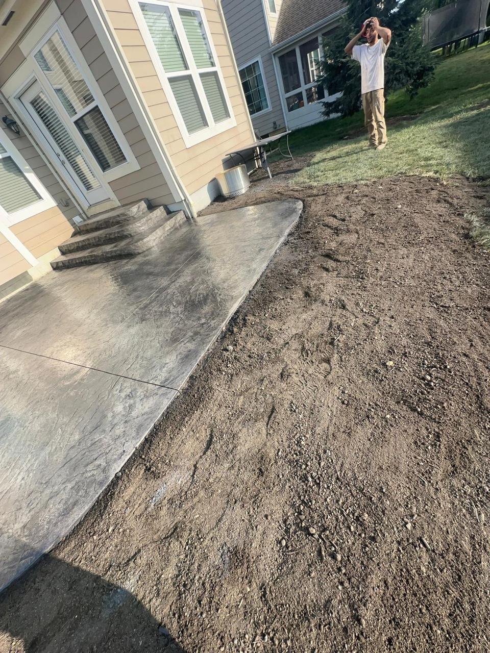 Large seamless stamped concrete patio with sweeping curved edge