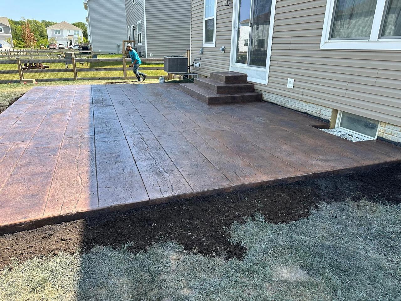 Polaris Concrete crew finishing a wood plank stamped patio in Columbus, Ohio