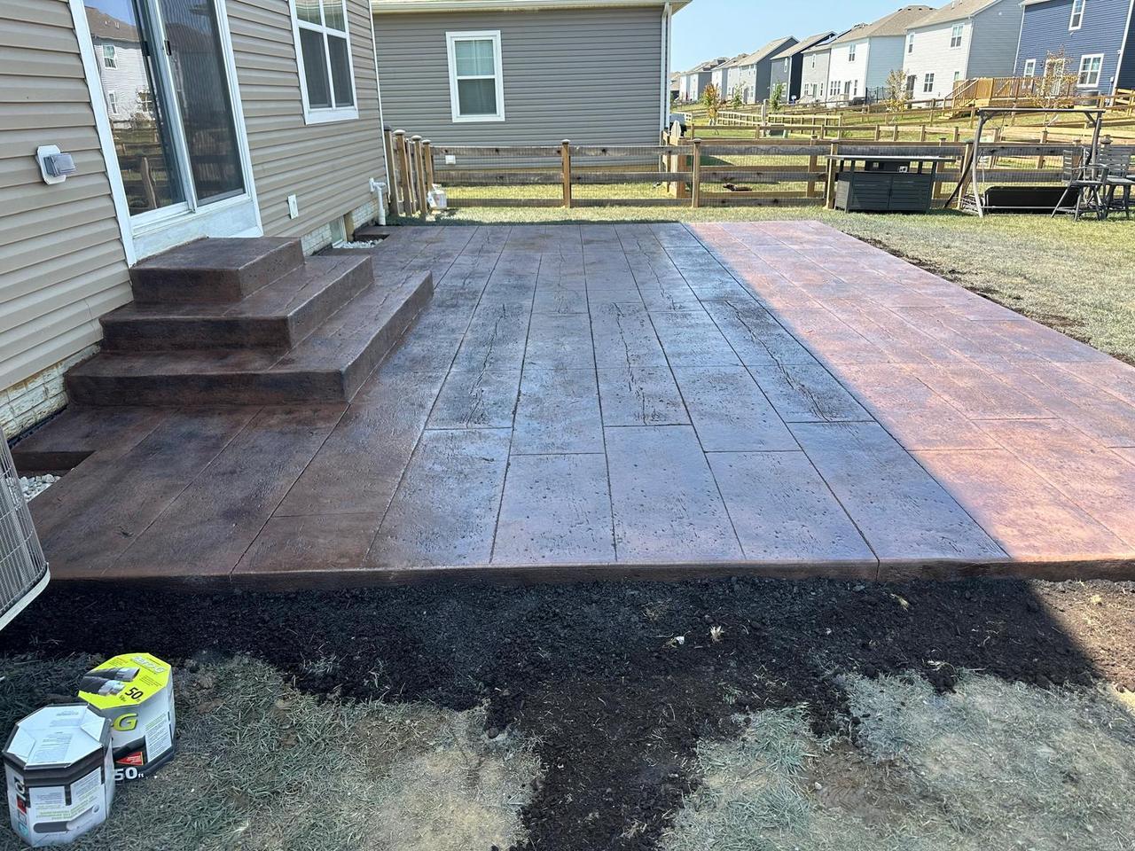 Two-tone wood plank stamped concrete patio with matching steps