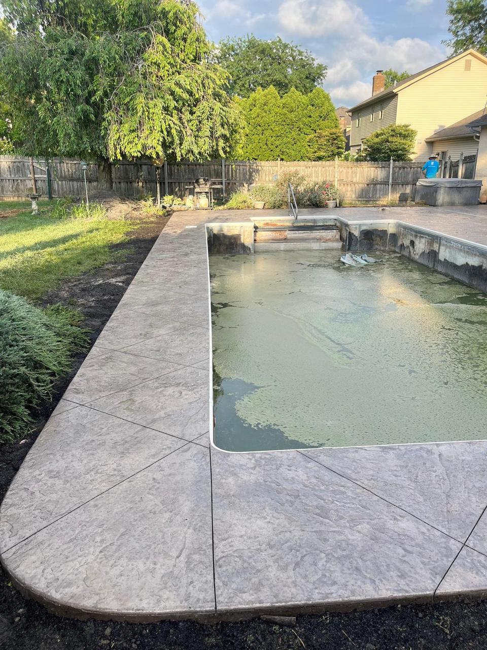 Stamped concrete pool deck with herringbone pattern