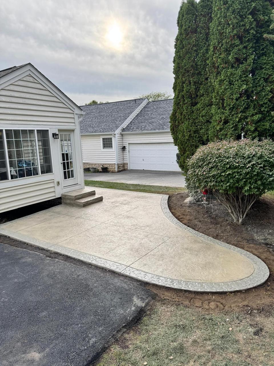 Cream stamped concrete walkway with contrasting border