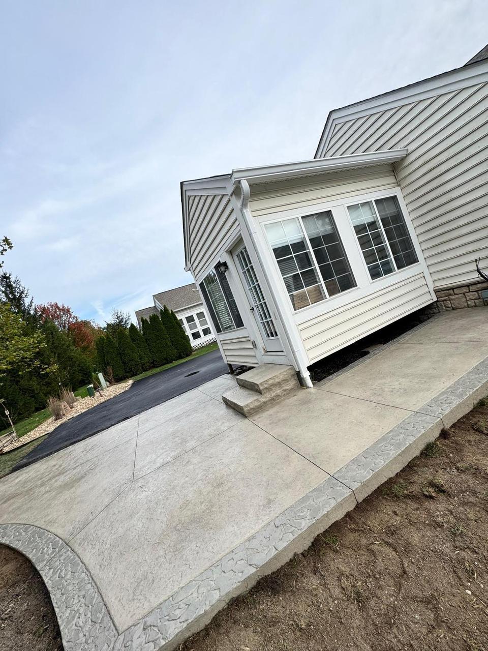 Stamped concrete walkway leading to the driveway